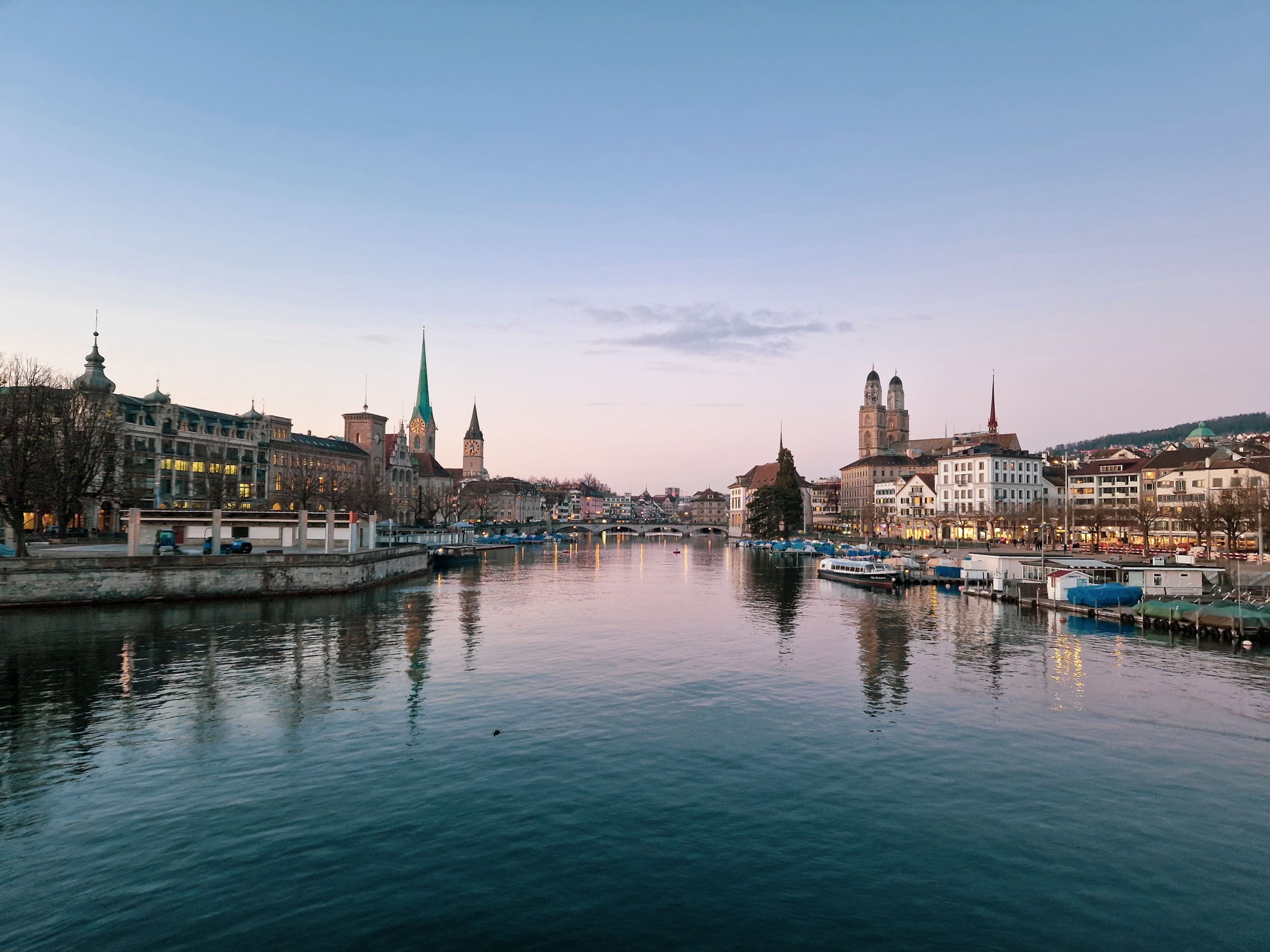 The Limmat in Zurich at dusk, with the Fraumünster, St. Peter and Grossmünster